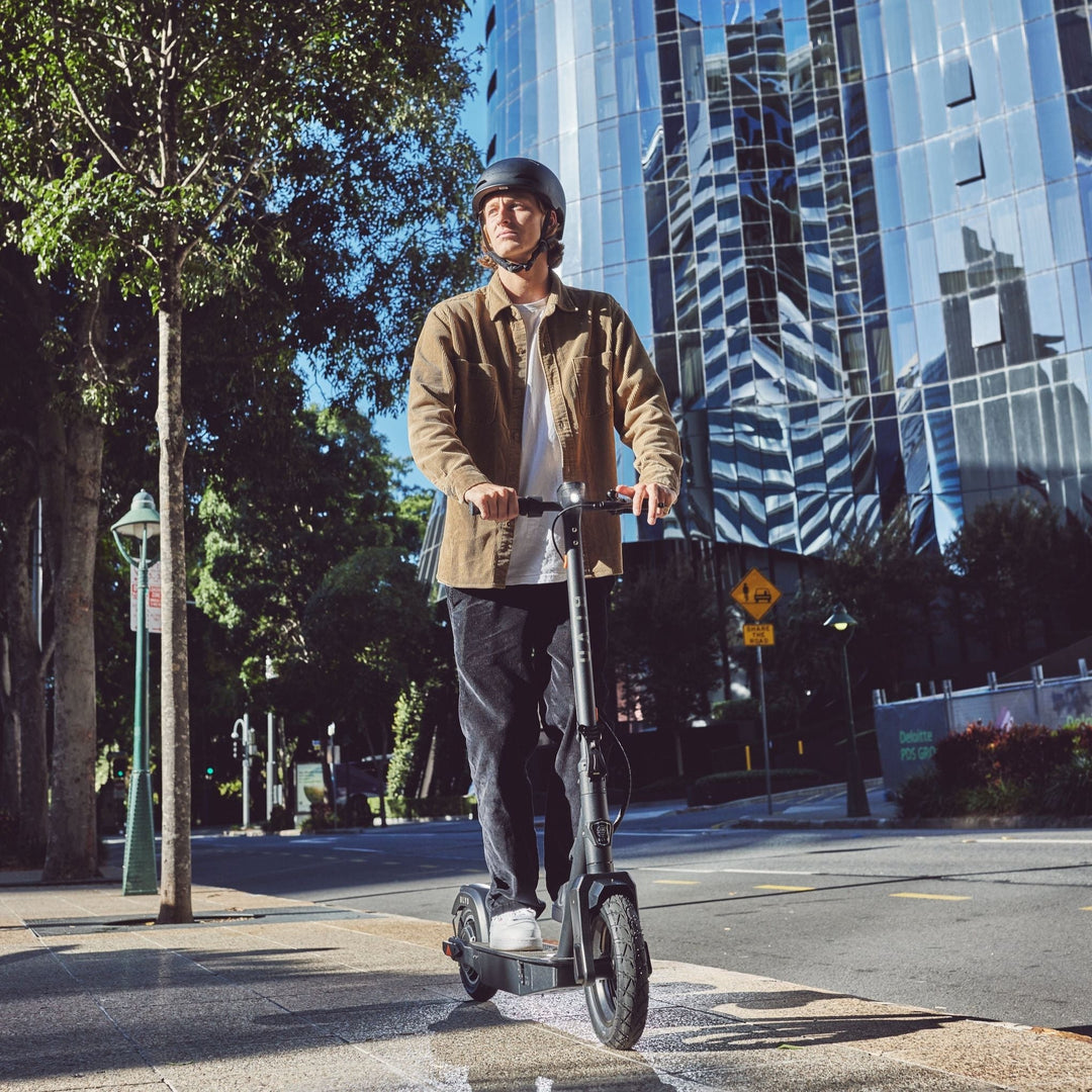 man riding a blvd elite electric scooter in the city
