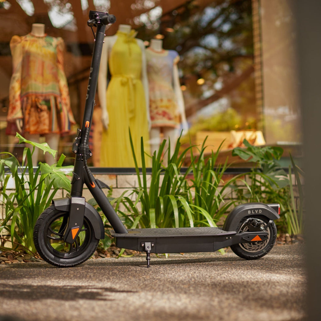 side view of a blvd elite electric scooter in front of shop window