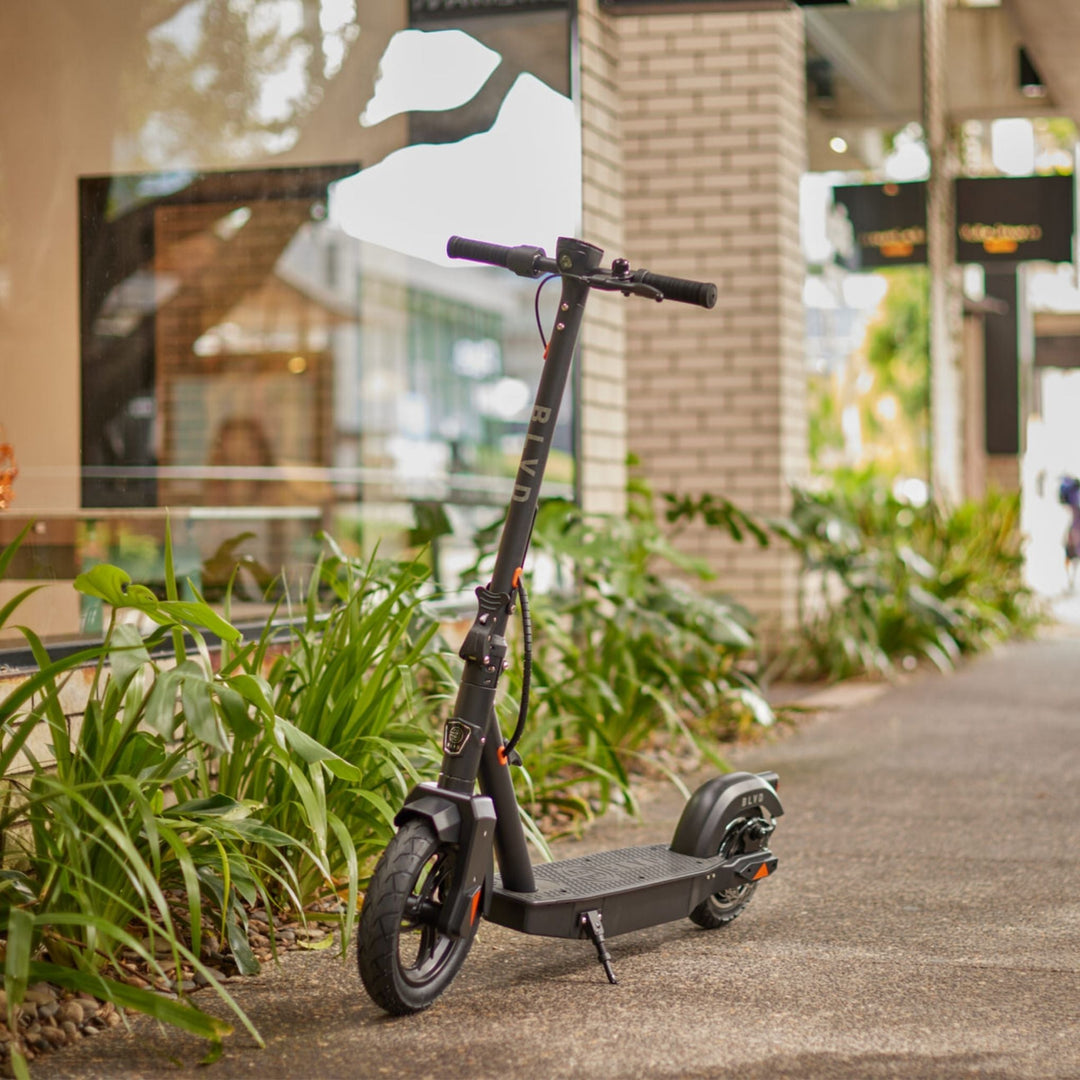 blvd elite electric scooter with kickstand down on walkway