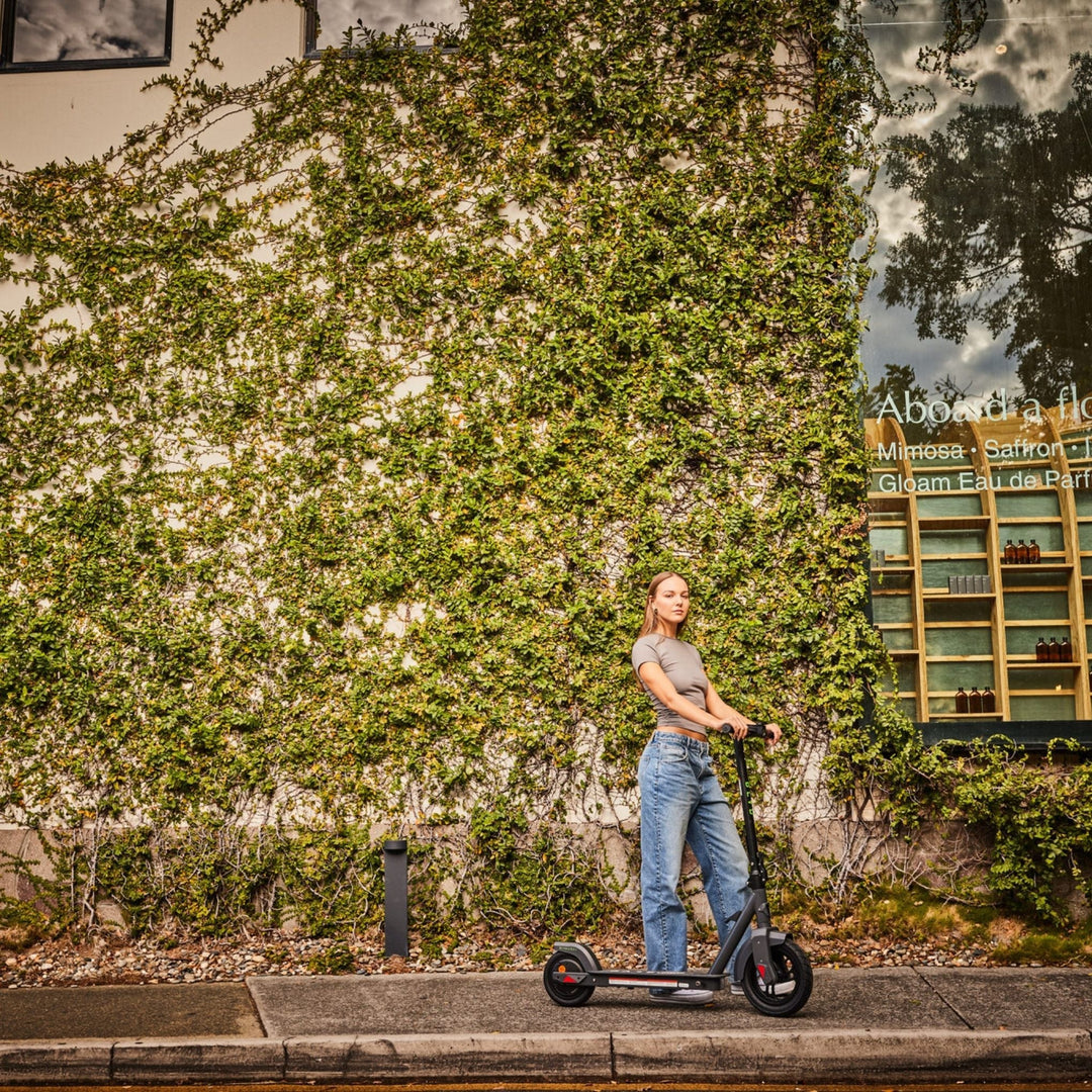 lady confidently holding a blvd urbn plus electric scooter